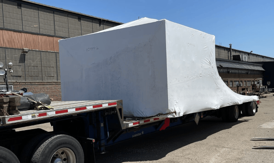 Large wrapped load secured on a Nonpareil Logistics flatbed