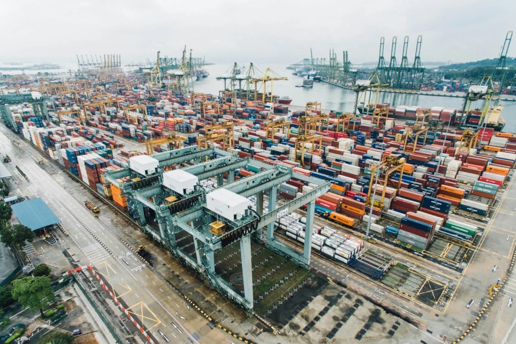 Aerial view of a busy port with stacked shipping containers